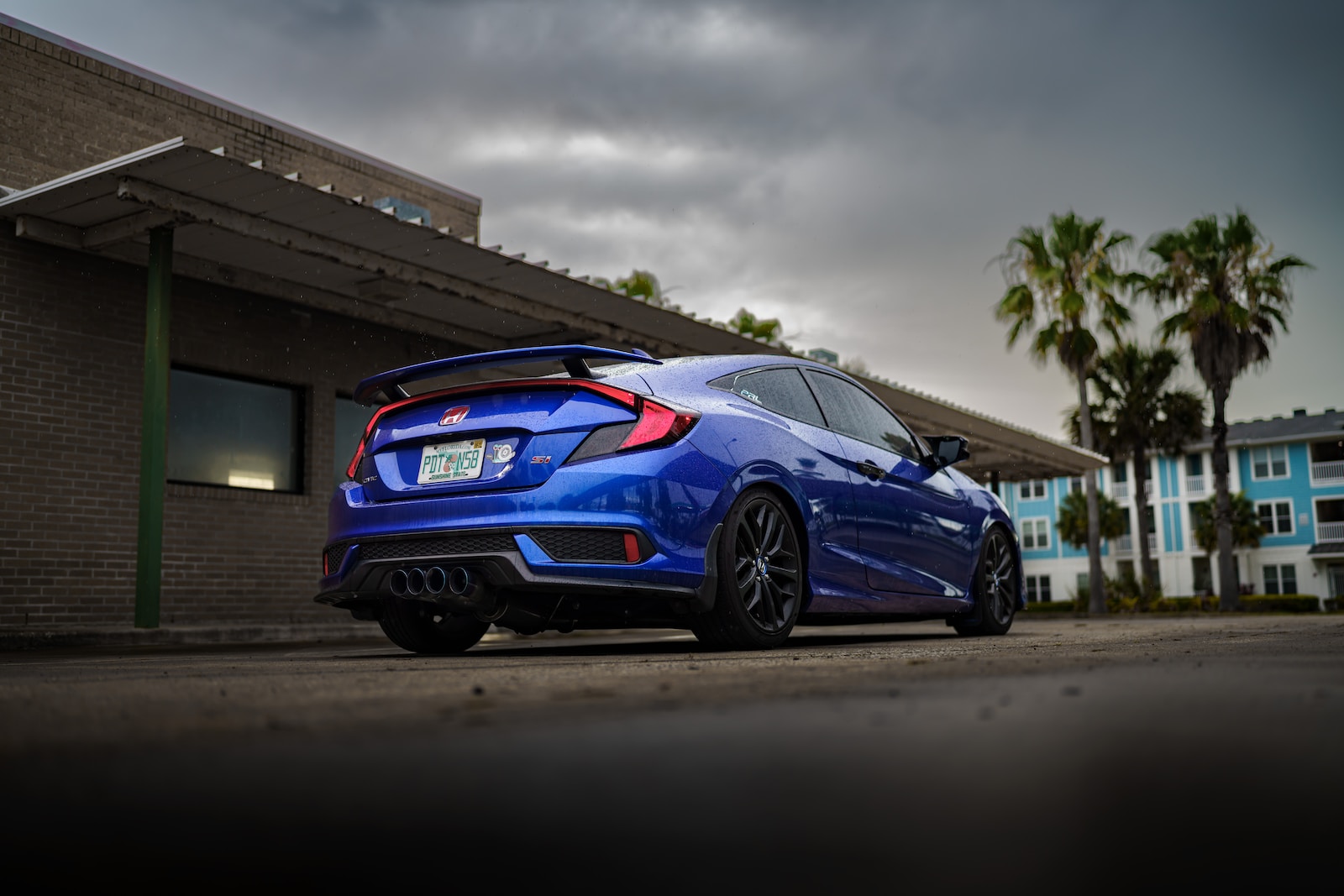 a blue car parked outside a building